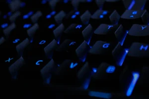 Close up of a backlit keyboard with illuminated keys representing keyboard reprinting and refurbishment services