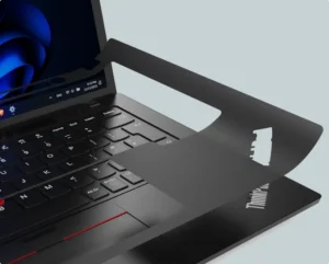 Laptop keyboard with stencil overlay showing keyboard reprinting process for refurbished devices