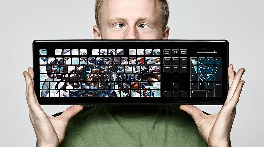 Person holding a customized keyboard with printed keys showcasing keyboard reprinting and personalization services